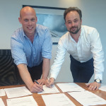 Binns Fencing's managing director Adam Binns (left) and Alastair Henman of Zaun sign on the dotted line